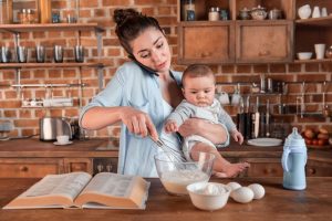 Busy mom baking with her baby